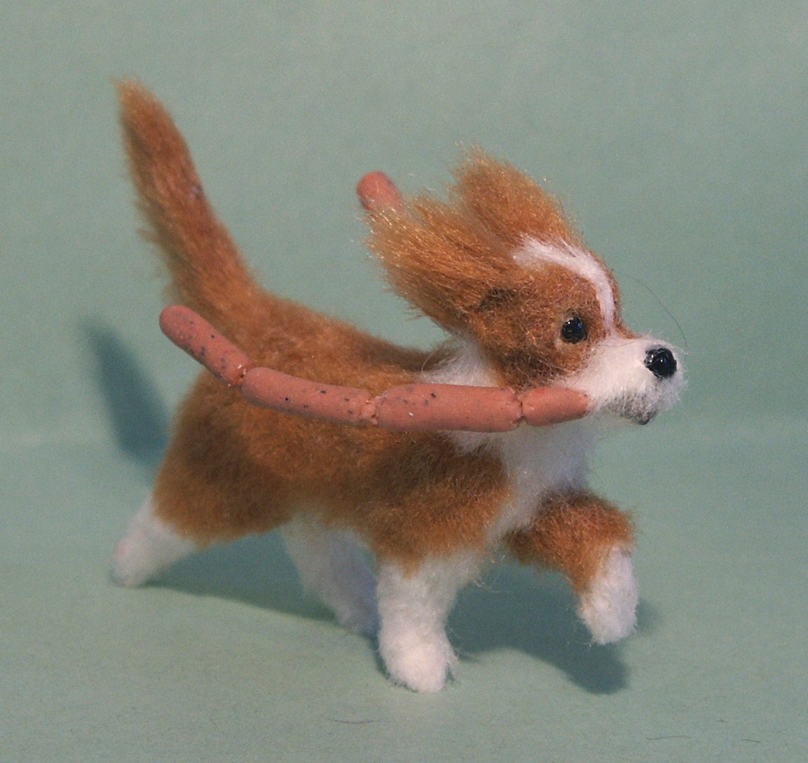 Dolls house dog with sausages