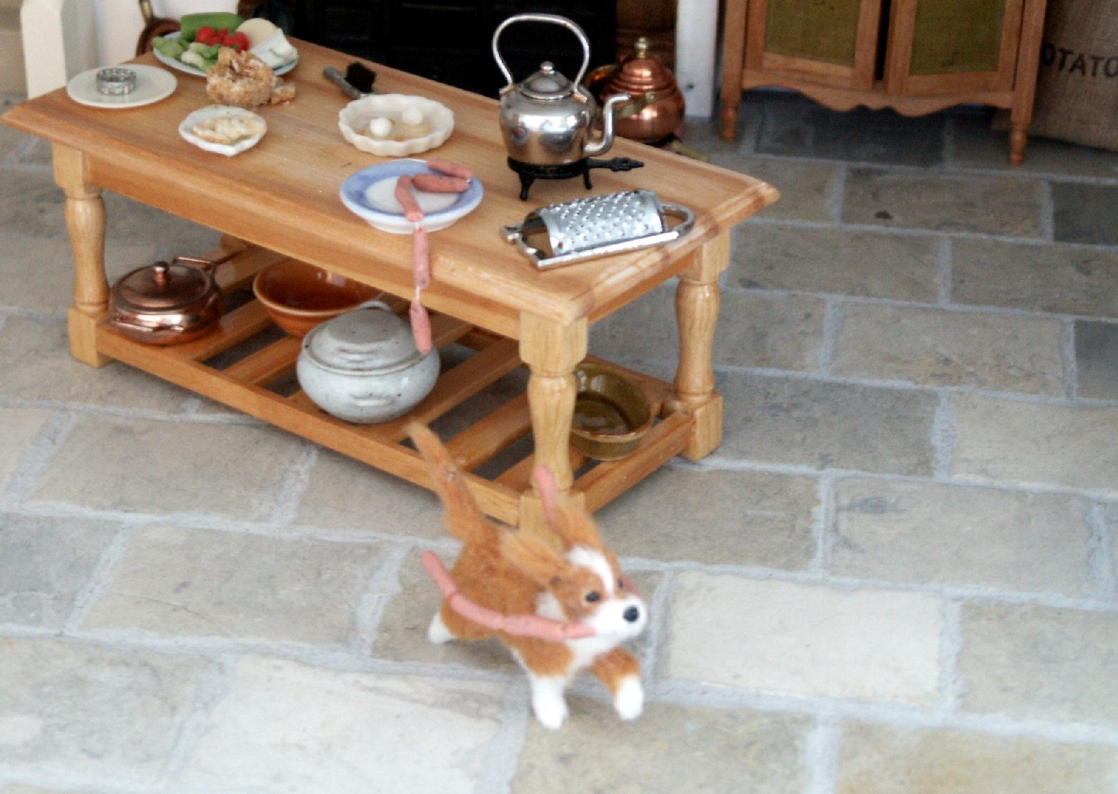 Dolls house dog with sausages