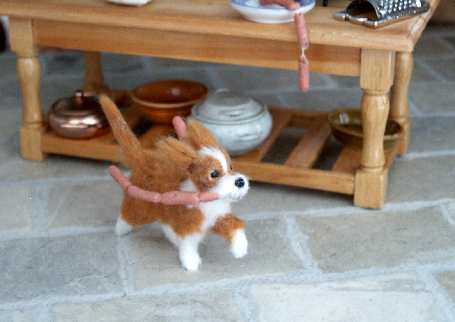 Dolls house dog with sausages