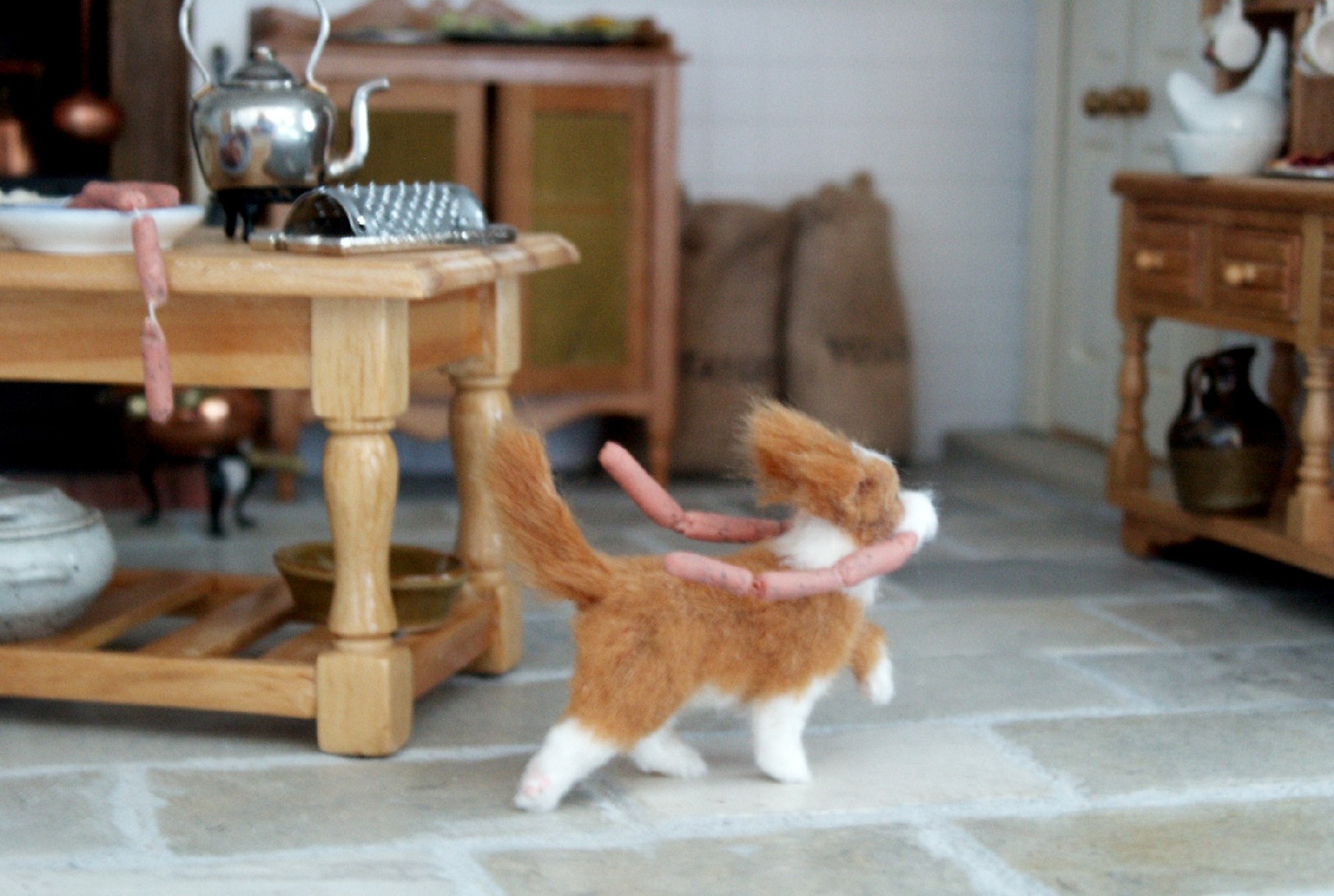 Dolls house dog with sausages