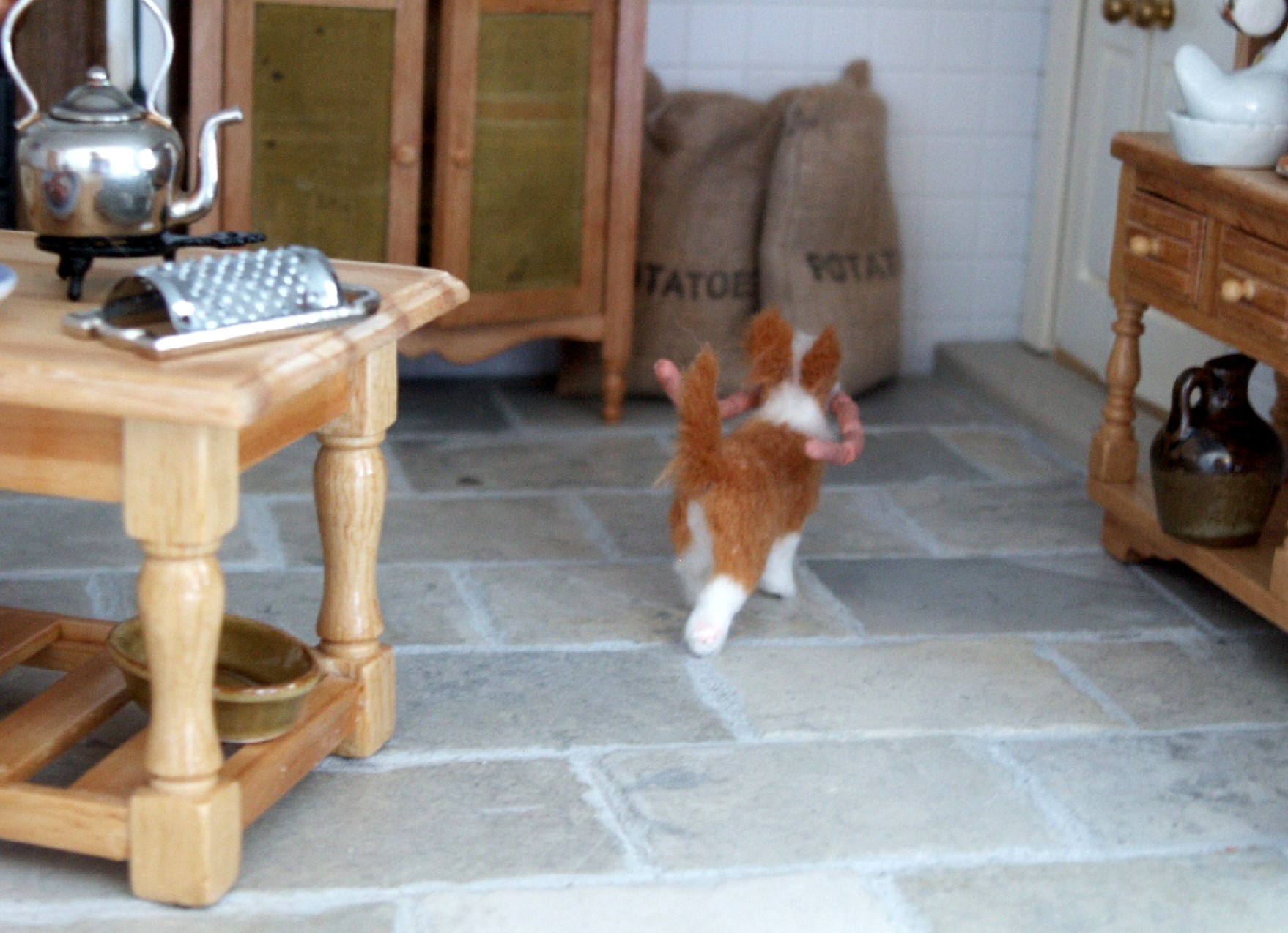 Dolls house dog with sausages